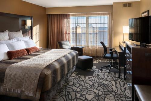 法戈俱乐部酒店和法戈套房的配有一张床和一台平面电视的酒店客房