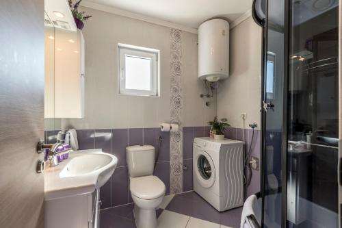 赫瓦尔赫瓦尔德鲁克西公寓酒店的浴室配有卫生间、盥洗盆和洗衣机。