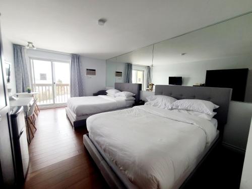 圣西蒙Horizon 777的酒店客房,设有两张床和镜子