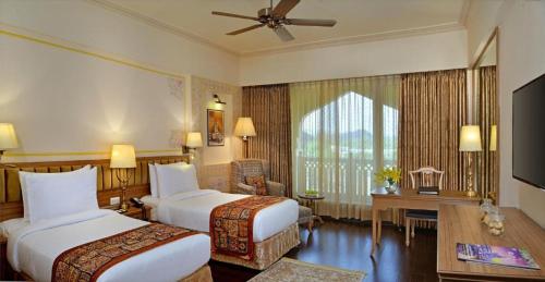 斋浦尔Indana Palace Jaipur的酒店客房配有两张床和一张书桌