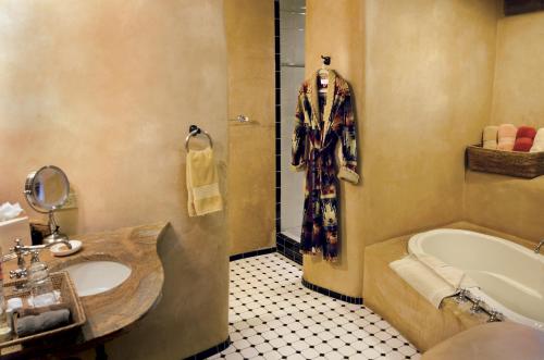塞多纳El Portal Sedona Hotel的浴室配有盥洗盆和浴缸。