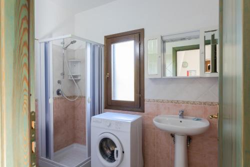布多尼Appartamenti Tanaunella的一间带洗衣机和水槽的浴室