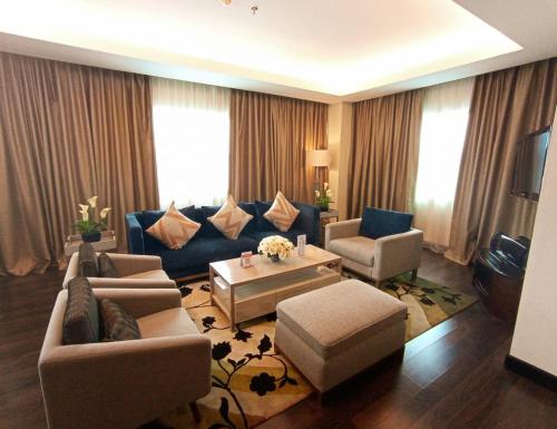 安汶安汶瑞雅酒店的客厅配有沙发、椅子和桌子