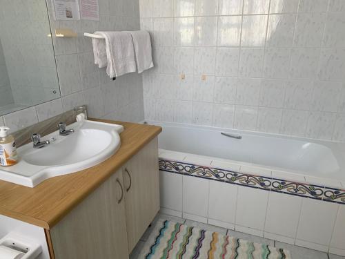 泰布尔维尤Arum Field Accommodation的浴室配有盥洗盆和浴缸。
