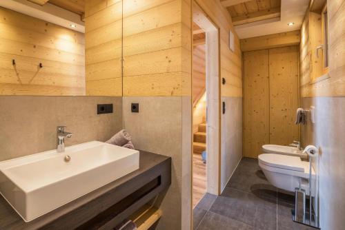 塞尔瓦德伊莫利尼Chalets Reisnock - Hochgruberhof的两张带水槽和卫生间的浴室图片