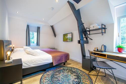 兰德赫拉夫高级庄园住宿的一间卧室配有一张大床、一张桌子和一张书桌