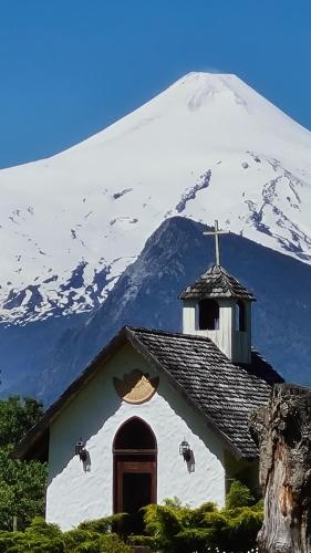 普孔萨尔托德尔卡利劳福酒店的一座教堂,其背景是一座白雪覆盖的山