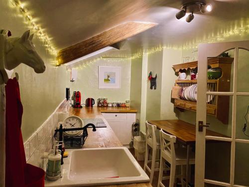 杜伦Cosy Cottage in Durham City的厨房设有水槽,天花板上设有马头