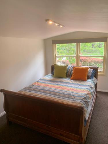 罗伯逊Misty Farms Barn的一间卧室配有带两个枕头的床和窗户