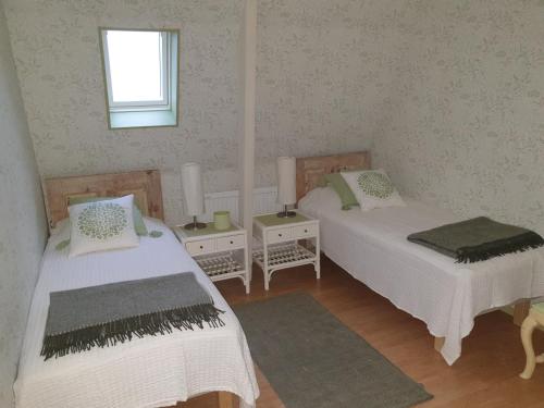 博里霍尔姆Marsjö Gård Bo & Yoga vandrarhem的客房设有两张床和窗户。