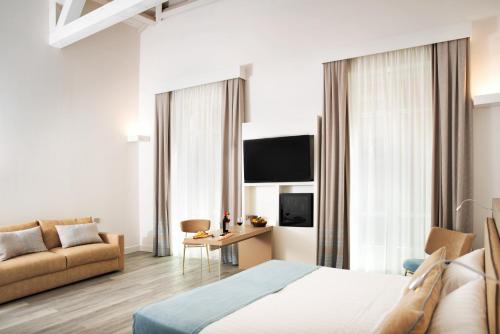 卡利亚里意大利酒店的酒店客房,配有床和沙发