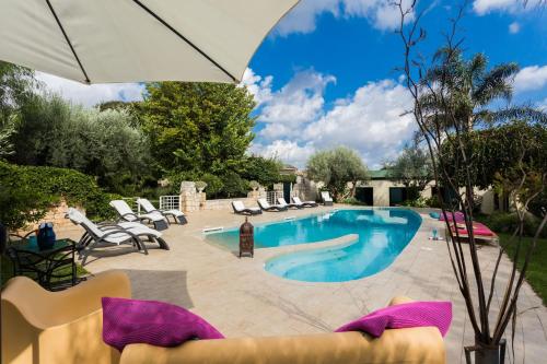 莫迪卡Stone House Modica的一个带椅子和遮阳伞的游泳池