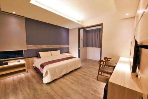 Shalu玉坤田商旅 的酒店客房,配有床和电视