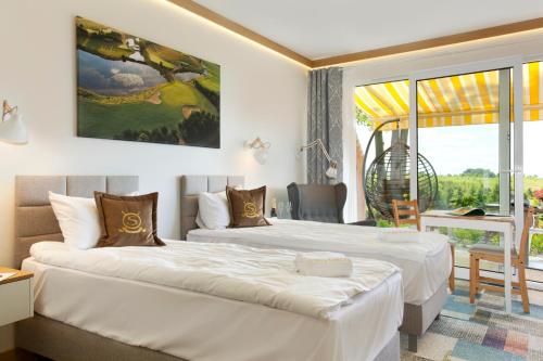 威赫罗伏Bungalows at Sierra Golf Resort的酒店客房设有两张床和一个阳台。