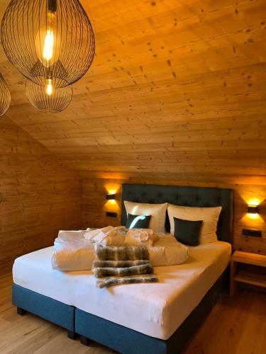 圣加伦基希Chalet RelaxAlp Garfrescha的一间卧室配有一张带木墙和灯的床