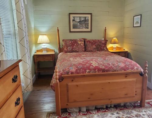 CrumplerThe Cabins at Healing Springs的一间卧室配有一张带2个床头柜和2盏灯的床。