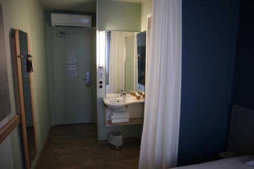 梅尔·莱斯·拜恩斯勒特雷波尔梅尔莱班宜必思快捷酒店的一间带水槽和镜子的浴室