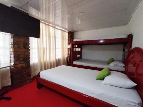 佛罗里达布兰卡Hotel Casablanca Cañaveral的一间卧室配有两张双层床和红地毯