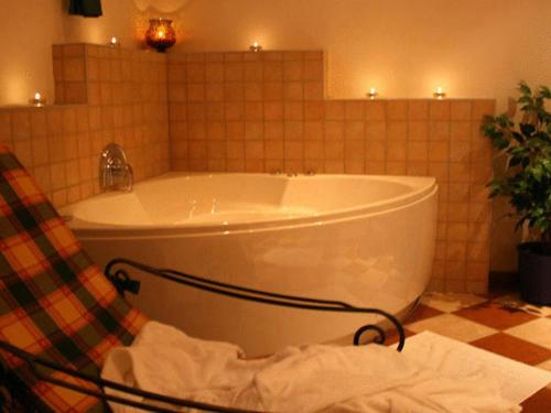 阿特湖塞布利克酒店的带浴缸的浴室,铺有瓷砖地板