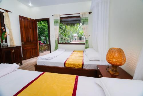 Mỹ Khánh Resort客房内的一张或多张床位