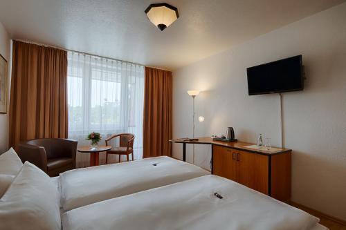 柏林附近贝尔瑙贝尔瑙舒适酒店的酒店客房设有两张床和电视。