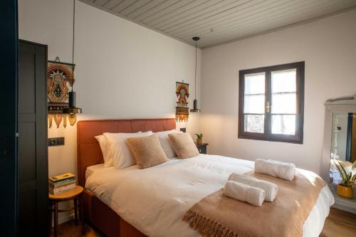 马克里尼撒Philos Guesthouse的一间卧室配有一张大床和两条毛巾