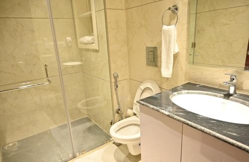 巴雷利Hotel Aakriti Clarks Inn Express的带淋浴、盥洗盆和卫生间的浴室