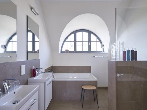德兰斯克Reetland am Meer - Premium Reetdachvilla mit 3 Schlafzimmern, Sauna und Kamin E16的白色的浴室设有浴缸和水槽。