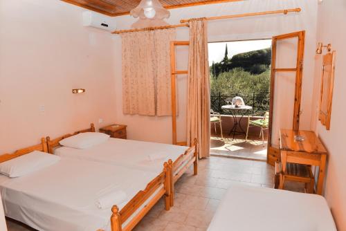 帕莱欧卡斯提撒乐园公寓酒店的一间带两张床的卧室和一个带桌子的阳台