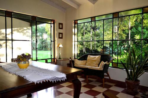 坦迪尔坎普阿卡西亚斯宾馆的客厅配有桌椅和大窗户