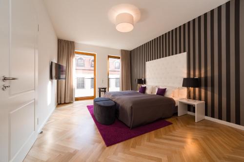 德累斯顿Modernes Apartment am Neumarkt的一间卧室配有一张床和紫色地毯