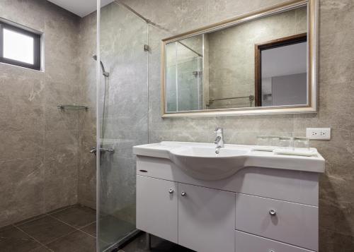 鹿谷乡名竹旅社 Minzu Hotel的一间带水槽和玻璃淋浴的浴室