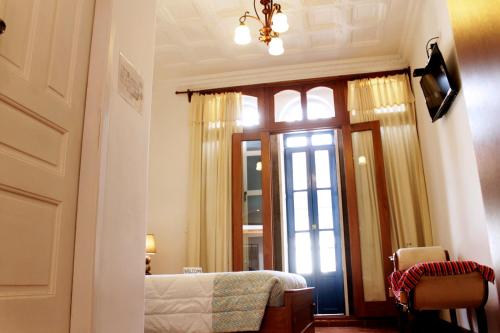 基多加斯广场酒店的一间卧室设有一张床和一个大窗户