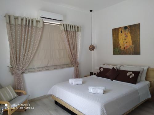 马塔拉Hotel Orama-Matala的卧室配有白色的床和窗户。