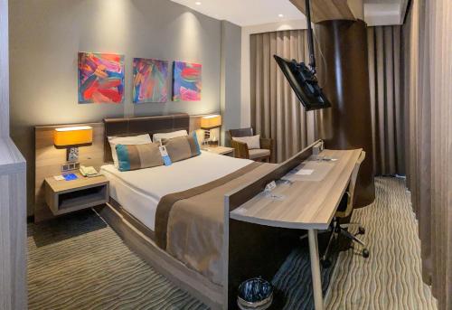 安卡拉欧斯蒂姆帕克商务酒店的配有一张床和一张书桌的酒店客房