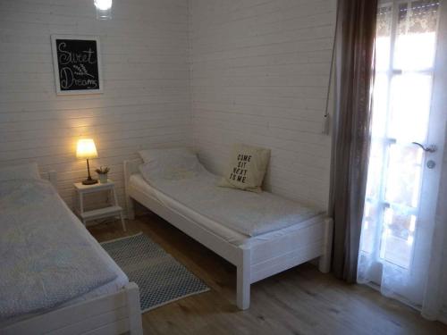 鲍洛通凯赖斯图尔Holiday Homes in Balatonmariafürdo 19438的小房间设有床和窗户