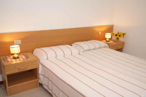 莱德罗Apartments in Pieve di Ledro/Ledrosee 22632的一间卧室配有一张带2个床头柜的大床