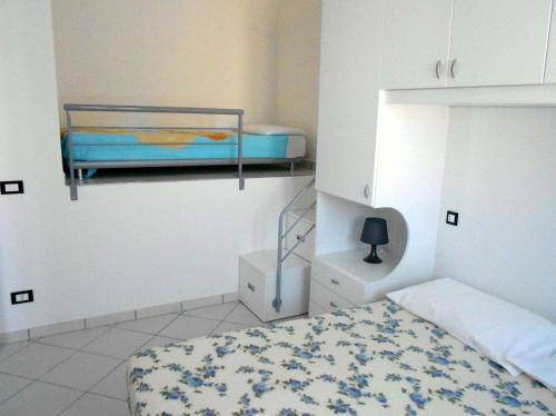 罗索利纳马雷滨海罗索利纳4号度假屋的一间卧室配有一张床和一张双层床。