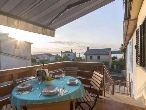 奈维斯Apartment in Njivice/Insel Krk 27855的阳台上的一张桌子和一张蓝色桌布