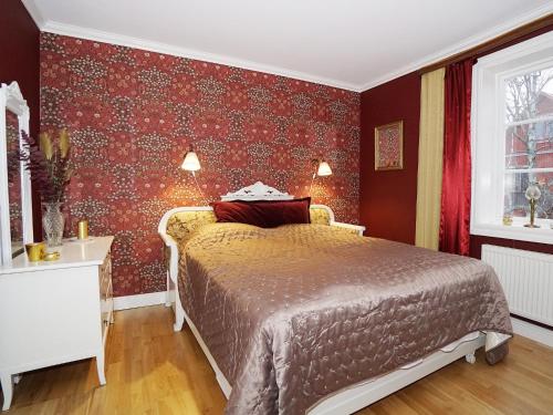 耶尔夫瑟Condis Lägenheten的一间卧室配有一张红色墙纸床