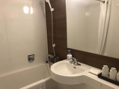 铫子市Sunrise Choshi的浴室配有盥洗盆、镜子和浴缸