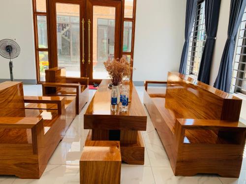 广义Khách sạn ĐẢO LÝ SƠN- AN DUYÊN的客厅设有木长椅和桌子