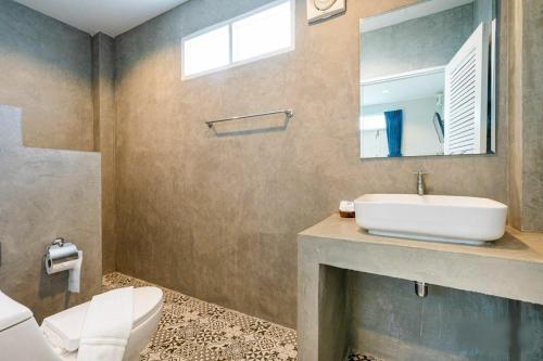 七岩Bianco House Resort的一间带水槽、卫生间和镜子的浴室