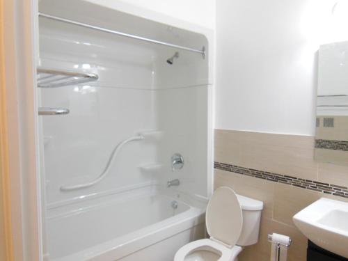 米西索加NU多伦多机场酒店的带淋浴、卫生间和盥洗盆的浴室
