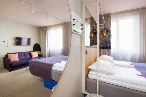 奥斯陆卡尔约翰斯堪迪克酒店的酒店客房,设有两张床和一张沙发