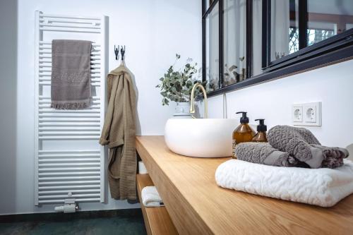 罗孚尔Der Steinerwirt - hangout & hotel的木制柜台上带水槽的浴室