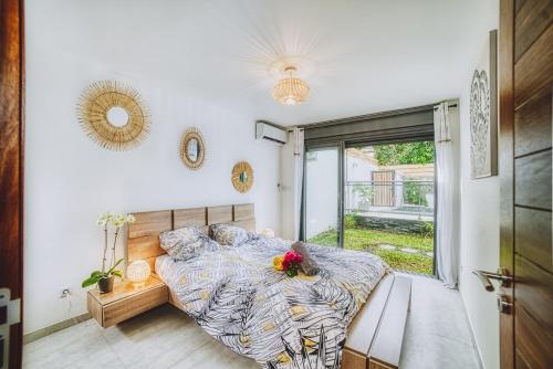 Ravine des CabrisVILLA TAMARIN的一间卧室设有一张床和一个大窗户