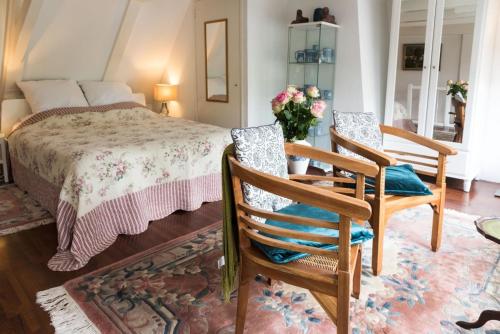 阿姆斯特丹普林森公寓住宿加早餐旅馆的一间卧室配有一张床和两把椅子