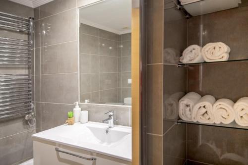 德拉托亚岛P18 Villalia Apartamento B en la Isla de la Toja的浴室配有盥洗盆、镜子和毛巾