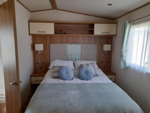 迪姆彻奇The Beaches - New Beach的一间卧室配有一张带蓝色枕头的大床
